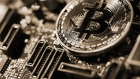 A coin representing Bitcoin cryptocurrency sits on a computer circuit board in this arranged photograph in London, U.K., on Tuesday, Feb. 6, 2018. Cryptocurrencies tracked by Coinmarketcap.com have lost more than $500 billion of market value since early January as governments clamped down, credit-card issuers halted purchases and investors grew increasingly concerned that last years meteoric rise in digital assets was unjustified. 