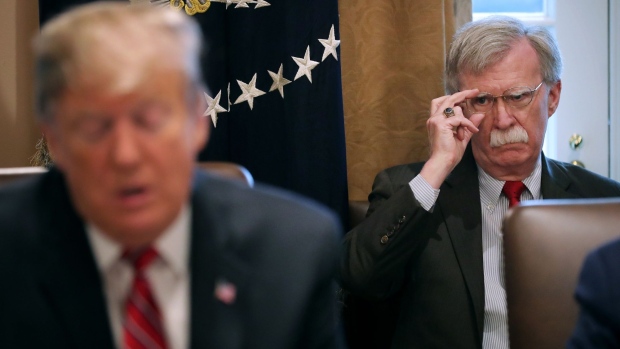 John Bolton listens to U.S. President Donald Trump talk to reporters during a meeting of his cabinet in the Cabinet Room at the White House Feb. 12, 2019.