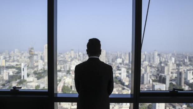 An employee looks out over Mumbai from a show home at Lodha Altamount, a luxury residential project developed by Lodha Developers Ltd., in Mumbai, India, on Monday, April 24, 2017. Lodha, one of India's largest property developers, will resume marketing apartments in the 75-story Trump Tower Mumbai development in the next few months, said Managing Director Abhishek Lodha. 
