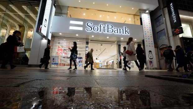 Pedestrians walk past a SoftBank Group Corp. store in Tokyo, Japan, on Thursday, Feb. 22, 2018. Billionaire founder Masayoshi Son said this month that the company will start preparing for the mobile IPO and aims for a listing within a year. It could still end up scrapping the plan, the company said on Feb. 7. 