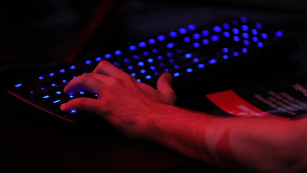 A gamer uses an illuminated keyboard at the Gamescom gaming industry event in Cologne, Germany, on Tuesday, Aug. 21, 2018. Gamescom is Germany's largest congress revolving around digital games, and acts as an interface with other cultural and creative branches, as well as with the digital economy according to their media site. 