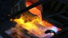 Molten silver catches alight as it pours into a mold during the casting of large silver ingots in the foundry at the JSC Krastsvetmet non-ferrous metals plant in Krasnoyarsk, Russia, on Friday, March 3, 2017. Krastsvetmet refines and releases nonferrous metals. 