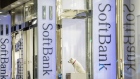 Pedestrians walk past signage for SoftBank Group Corp. outside a store in Tokyo, Japan, on Thursday, Nov. 29, 2018. SoftBank's 2.4 trillion yen ($21 billion) initial public offering of its Japanese telecommunications unit has successfully secured sales for the bulk of its shares to individual investors, people familiar with the matter said. 