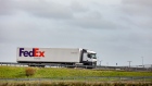 A cargo truck, operated by FedEx Corp., travels on a highway near the French border in Calais, France, on Monday, March 18, 2019. French cabinet last month approved a decree that would keep Eurostar trains running through Eurotunnel's Channel tunnel in the case of a so-called Hard Brexit. 