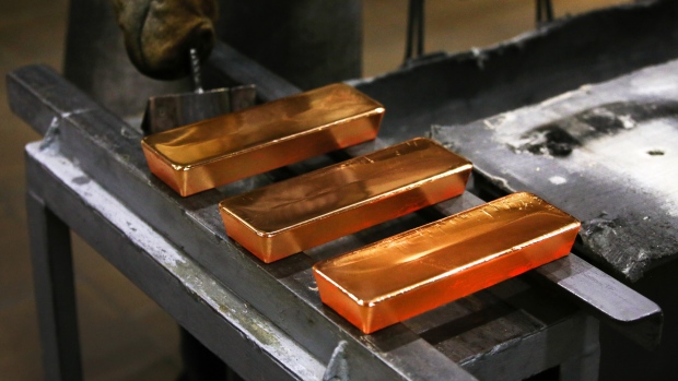Three red hot gold ingots cool after being removed from casting molds by a worker in the foundry at the JSC Krastsvetmet non-ferrous metals plant in Krasnoyarsk, Russia, on Friday, March 3, 2017. Krastsvetmet refines and releases nonferrous metals. 