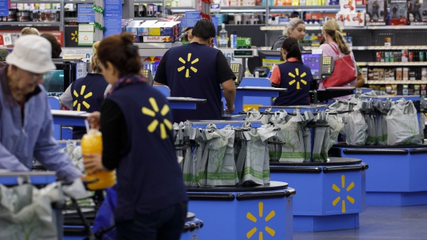 Cashiers ring up shoppers at a Walmart Inc. store in Burbank, California, U.S., on Monday, Nov. 19, 2018. To get the jump on Black Friday selling, retailers are launching Black Friday-like promotions in the weeks prior to the event since competition and price transparency are forcing retailers to grab as much share of the consumers' wallet as they can. 