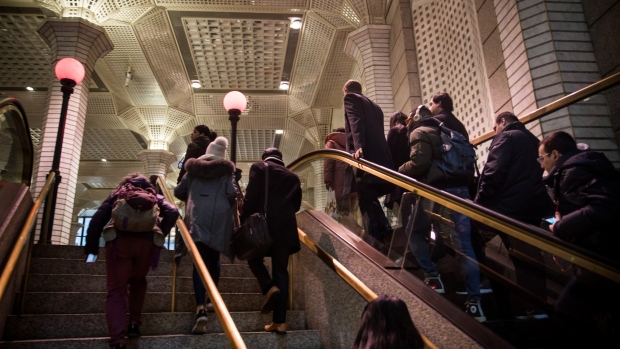 Commuters exit a Wall Street subway station near the New York Stock Exchange (NYSE) in New York, U.S., on Monday, March 11, 2019. U.S. stocks bounced back from the worst week of the year, as chipmakers rallied on deal news and the latest retail-sales data boosted confidence that the economy isn't headed for a downturn. 
