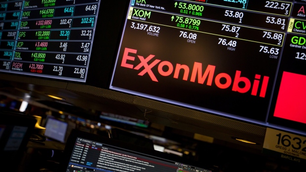 A monitor displays Exxon Mobil Corp. signage on the floor of the New York Stock Exchange (NYSE) in New York, U.S., on Friday, Feb. 9, 2018. The convulsions rocking U.S. equity markets continued Friday, with major indexes headed for the worst week in almost seven years after falling back from early gains. Treasury declines eased as investors sought havens from gold to the yen. 
