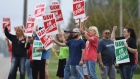 United Auto Workers members picket outside of the General Motors Lansing Delta Township plant 