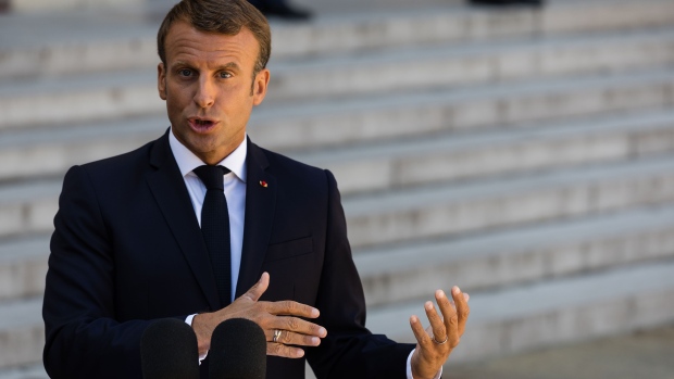 Emmanuel Macron, France's president, right, gestures as he delivers a statement in the courtyard of Elysee Palace in Paris, France, on Thursday, Aug. 22, 2019. Macron gave U.K. Prime Minister Boris Johnson little hope he’s prepared to compromise on Brexit and said any changes to the current deal won’t be very significant. 
