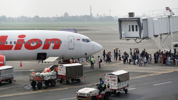 Passengers disembark from a Lion Air Group aircraft at Soekarno-Hatta International Airport in Cengkareng, near Jakarta, Indonesia, on Tuesday, Dec. 11, 2018. Lion Air's owner Rusdi Kirana is sketching out plans to become one of the world's largest budget carriers, while also preparing to scrap $22 billion in Boeing Co. jet orders out of anger at the manufacturer's response to an October air disaster. 