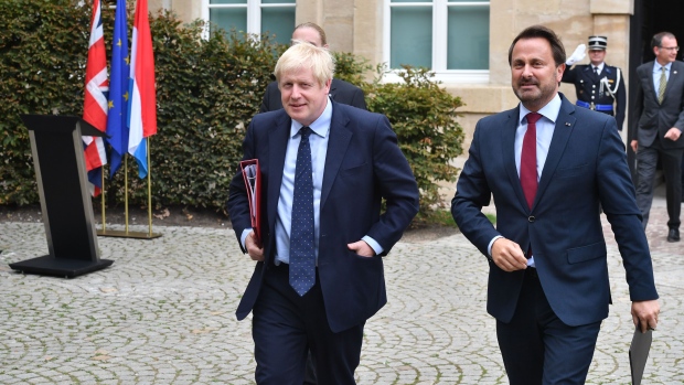 Boris Johnson, U.K. prime minister, left, departs following a Brexit meeting with Xavier Bettel, Lux