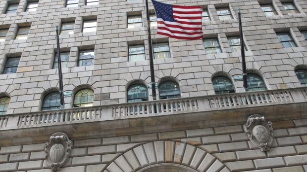 UNITED STATES - DECEMBER 15: The U.S. flag hangs on the facade of the Federal Reserve Bank of New York headquarters in New York, U.S., on Monday, Dec. 15, 2008. The Federal Reserve Bank of New York hired executive search firm Korn/Ferry International to help find a replacement for its bank president Timothy Geithner. (Photo by Daniel Acker/Bloomberg via Getty Images) 
