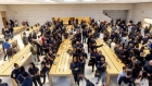 Employees applaud while greeting customers at the newly redesigned Apple store on Fifth Avenue in New York on Sept. 20, 2019. 