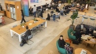 Members sit at the WeWork Cos. Iceberg co-working space in Tokyo. 