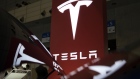 Tesla Motors Inc. logo is displayed at the Tesla Motors Inc. booth at the Combined Exhibition of Advanced Technologies (CEATEC) in Chiba, Japan, on Tuesday, Oct. 4, 2016. The show runs through Oct. 7. 