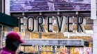 A pedestrian passes in front of a Forever 21 Inc. store in the Times Square neighborhood of New York, U.S., on Thursday, Aug. 29, 2019. Forever 21 Inc. is preparing for a potential bankruptcy filing as the fashion retailer’s cash dwindles and turnaround options fade, according to people with knowledge of the plans. 