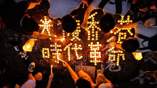 Demonstrators light candles during a protest outside Prince Edward station, Sept. 30. Photographer: Eduardo Leal/Bloomberg