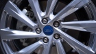 A Ford decal sits on the wheel hub of a Kuga hybrid automobile on display during a Ford Motor Co. launch event in Amsterdam, Netherlands, on Tuesday, April 2, 2019. Ford launched 16 new products as part of an electrification drive, half of which will go on sale by end of this year. 