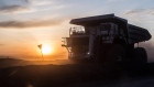 The sun sets over a dump truck 