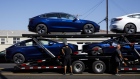 Workers unload Tesla Inc. Model 3 electric vehicles from a car carrier outside the company's delivery center in Marina Del Rey, California, U.S., on Saturday, Sept. 29, 2018. Tesla brought the total number of Model 3 produced in the third quarter to over 51,000 vehicles. Photographer: Patrick T. Fallon/Bloomberg