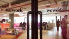 Signage is displayed on glass doors at a WeWork co-working space in Gurugram, India. 