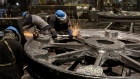 Workers use grinders to smooth down the manufactured parts for industrial equipment at a facility in Columbus, Ohio. 