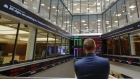 An employee views a FTSE share index board in the atrium of the London Stock Exchange Group Plc's offices in London, U.K., on Wednesday, May 29, 2019. While the FTSE 100 Index has climbed about 15 percent since June 2016 in local currency, it's down in both euro and dollar terms. 