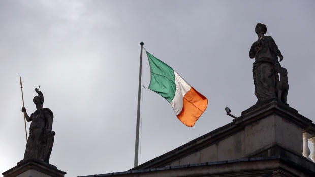 The Irish national flag flies above the Post Office building on O'Connell Street in Dublin, Ireland, on Thursday, Nov. 24, 2016. 