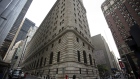 Pedestrians walk past the New York Federal Reserve building in New York, U.S., on Wednesday, Oct. 17, 2012.