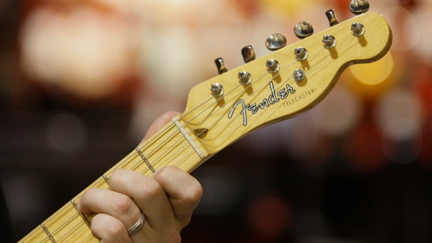 An employee plays a Fender Telecaster guitar at a Best Buy in Downers Grove, Ill.