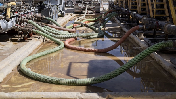 Hoses carry water to hydraulic fracking machinery at at a site near Mentone, Texas. 
