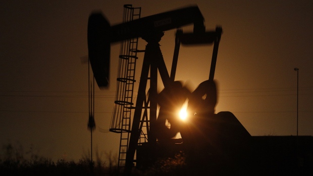 The silhouette of an electric oil pump jack is seen at dusk in the oil fields surrounding Midland, Texas, U.S., on Tuesday, Nov. 7, 2017. Nationwide gross oil refinery inputs will rise above 17 million barrels a day before the year ends, according to Energy Aspects, even amid a busy maintenance season and interruptions at plants in the U.S. Gulf of Mexico that were clobbered by Hurricane Harvey in the third quarter. 