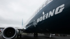 The Boeing Co. logo sits on the side of a 737 Max aircraft during preparations ahead of the Farnborough International Airshow 2016 in Farnborough, U.K.