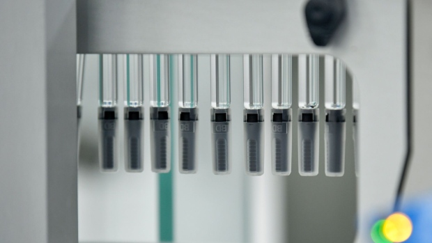 Pre-filled syringes hang on a production line at AstraZeneca Plc's new Biologics factory in Sodertalje, Sweden, on Thursday, April 11, 2019. AstraZeneca raised its annual sales forecast, helped by demand for the U.K. drugmaker's roster of new cancer drugs. 