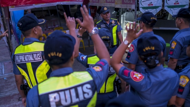 Officers with the Philippine National Police gather at the start of the country's mid-term election in Manila, Philippines, on Monday, May 13, 2019. Voters in the Southeast Asian nation go to the polls on Monday to elect new lawmakers and local government officials. 