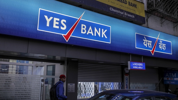A customer exits a Yes Bank Ltd. branch in Mumbai, India, on Tuesday, April 30, 2018. Shares of Yes Bank slumped 29 percent on Tuesday, its biggest decline on record after the lender headed by newly appointed Chief Executive Officer Ravneet Gill reported a surprise quarterly loss. 