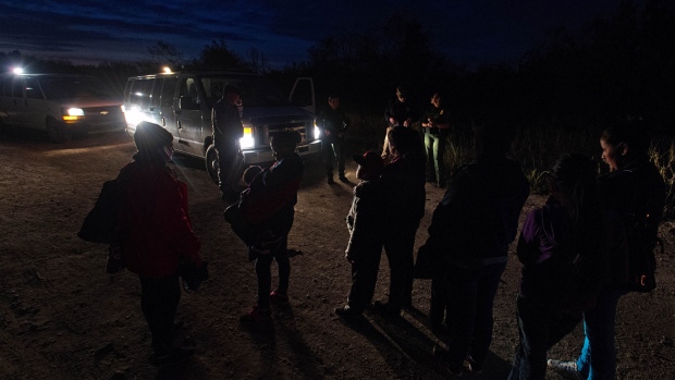 U.S. Border Patrol agents speak to suspected immigrants near the U.S.-Mexico border in McAllen, Texas. 