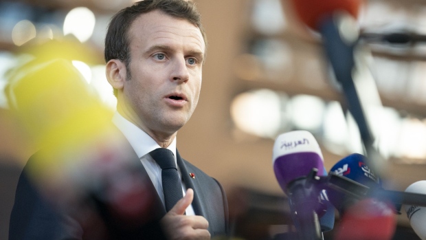 Emmanuel Macron, France's president, speaks to journalist as he arrives for a European Union leaders summit in the Europa building in Brussels, Belgium, on Wednesday, April 10, 2019.