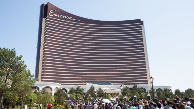 Guests wait in line outside of the Wynn Resorts Ltd. Encore Boston Harbor casino during an opening day event in Everett, Massachusetts, U.S., on Sunday, June 23, 2019. Wynn opened the $2.6 billion casino near Boston on Sunday, and expects to pack the resort with 15,000 to 20,000 people a day, many from outside the U.S. 