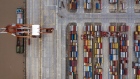 A container ship is docked next to a gantry crane as shipping containers sit stacked at the Yangshan Deepwater Port, operated by Shanghai International Port Group Co. (SIPG), in this aerial photograph taken in Shanghai, China, on Friday, May 10, 2019. The U.S. hiked tariffs on more than $200 billion in goods from China on Friday in the most dramatic step yet of President Donald Trump's push to extract trade concessions, deepening a conflict that has roiled financial markets and cast a shadow over the global economy. 