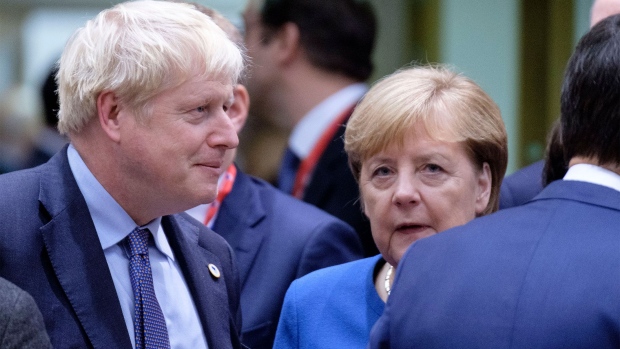 BRUSSELS, BELGIUM - OCTOBER 17, 2019: Prime Minister of the United Kingdom Boris Johnson (L) is talking with the German Chancellor Angela Merkel (R) at the start of an EU leaders summit on October 17, 2019 in Brussels, Belgium. EU and British negotiators came to an agreement earlier today on the United Kingdom's departure from the EU know as Brexit. (Photo by Thierry Monasse/Getty Images)
