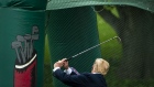 U.S. President Donald Trump swings a golf club during the White House Sports and Fitness Day event o