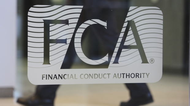 A logo sits on a window in the reception area of the headquarters of the Financial Conduct Authority (FCA) in the Canary Wharf business district in London, U.K. 