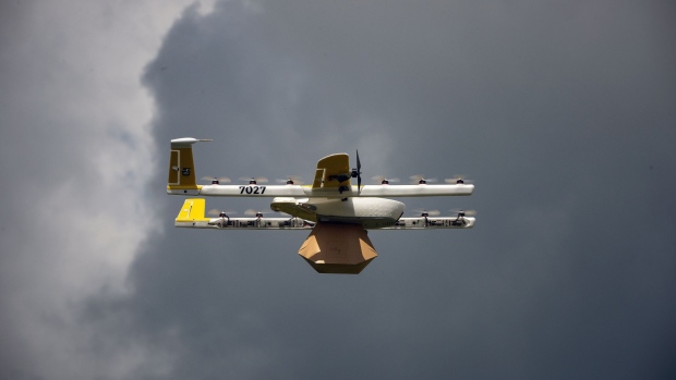 An Alphabet Inc. Google X Project Wing delivery drone flies during a demonstration at Virginia Tech in Blacksburg, Virginia, U.S., on Tuesday, Aug. 7, 2018. Project Wing aims to increase access to goods, reduce traffic congestion in cities, and help ease Carbon dioxide emissions. 
