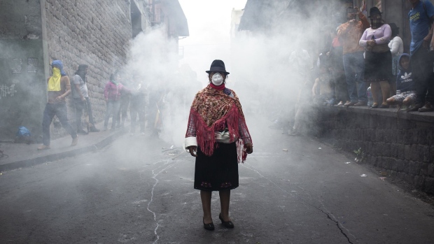 An indigenous woman wears a mask during a protest in Quito on Oct. 9. Photographer: David Diaz Arcos/Bloomberg