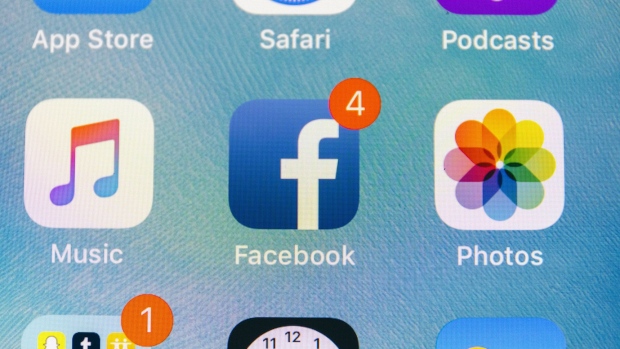 The Facebook Inc. application icon is displayed on an Apple Inc. iPhone in an arranged photograph taken in New York, U.S., on Thursday, July 26, 2018. Facebook shares plunged 19 percent Thursday after second-quarter sales and user growth missed Wall Street estimates. 
