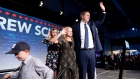 Andrew Scheer waves to supporters as he leaves the stage with his children at Conservative Party HQ 