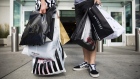 Shoppers hold retail bags in an arranged photograph at Yorkdale mall in Toronto, Ontario, Aug. 22, 2
