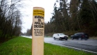 A petroleum pipeline crossing marker stands near the Kinder Morgan facility in Burnaby, British Columbia, Canada, on Wednesday, April 11, 2018. 